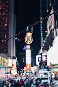 Illuminated light bulbs on city street