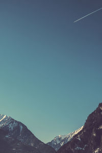 Low angle view of mountain against clear blue sky