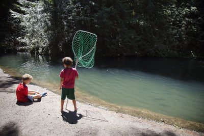 Boys fishing in river