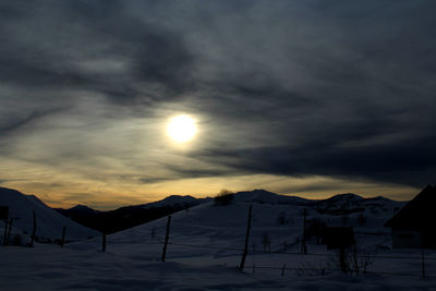 Scenic view of mountain range against cloudy sky