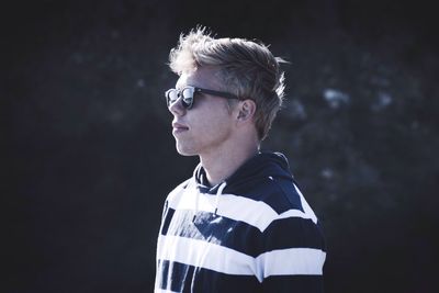 Man wearing sunglasses and striped t-shirt on sunny day