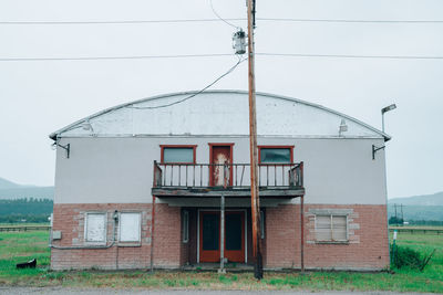 Built structure on field against sky