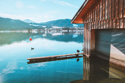 Wooden fishing house on the coast of the lake tegernsee. mountains in bavaria. beautiful landscape