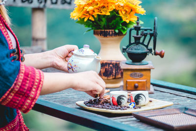 Midsection of woman preparing food on table