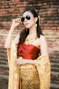 Portrait of young woman standing outdoors