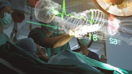 A surgeon diagnose a woman's heart problem via a holographic body scan before surgical procedure