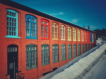 Red building against sky in winter