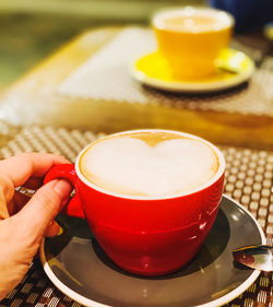 Cropped image of person holding coffee cup