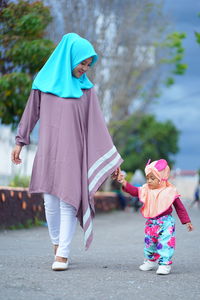 Rear view of women with umbrella