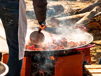 Man preparing food on barbecue grill