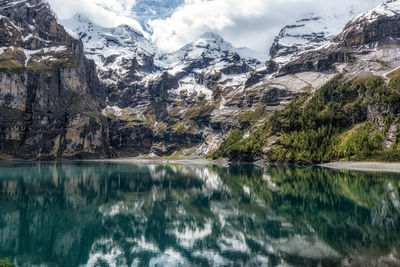 The view of oeschinenee lake and oeschinen valley amongst bernese alps mountain tops. 