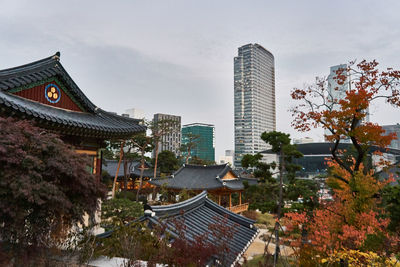 Panoramic view of buildings in city against sky