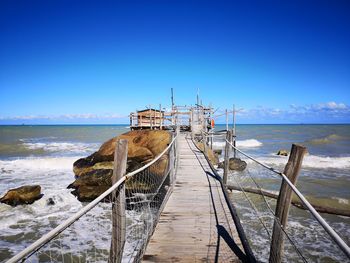 Scenic view of sea against clear blue sky