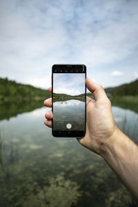 Reflection of hand holding smart phone