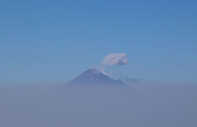 Scenic view of mountains against blue sky