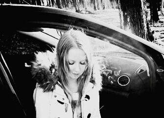 Portrait of young woman in car