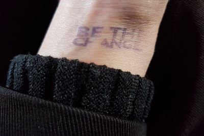 Close-up of woman against black background