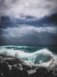 Scenic view of sea against cloudy sky