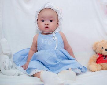 Portrait of cute baby girl sleeping on bed at home