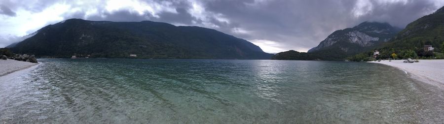 Panoramic view of sea and mountains against sky