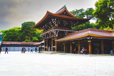 Group of people outside temple against building