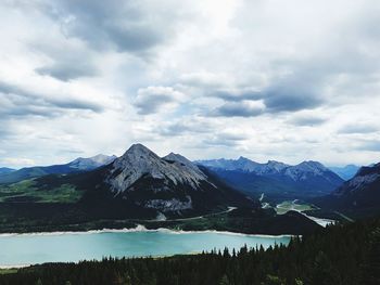 Scenic view of lake and mountains against sky