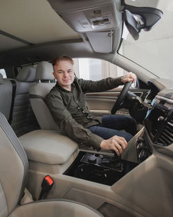 Portrait of woman using mobile phone while sitting in car