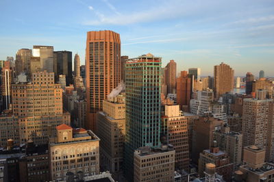 Aerial view of buildings in city against sky