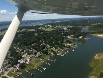 Aerial view of sea with cityscape in background