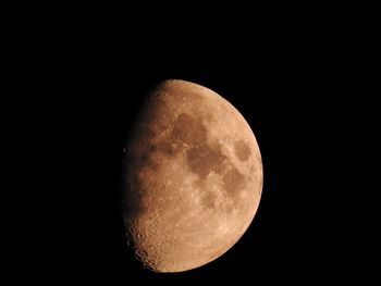 Low angle view of moon against clear sky at night