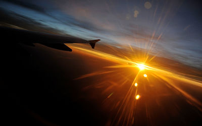 Cropped image of airplane flying over clouds