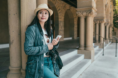 Portrait of young woman holding smart phone