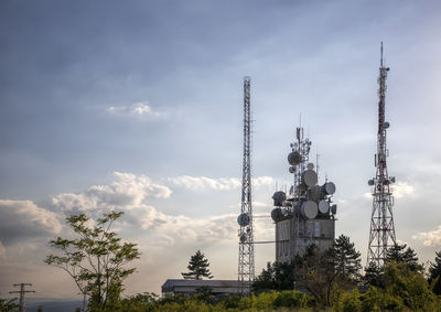 Low angle view of communications tower against sky