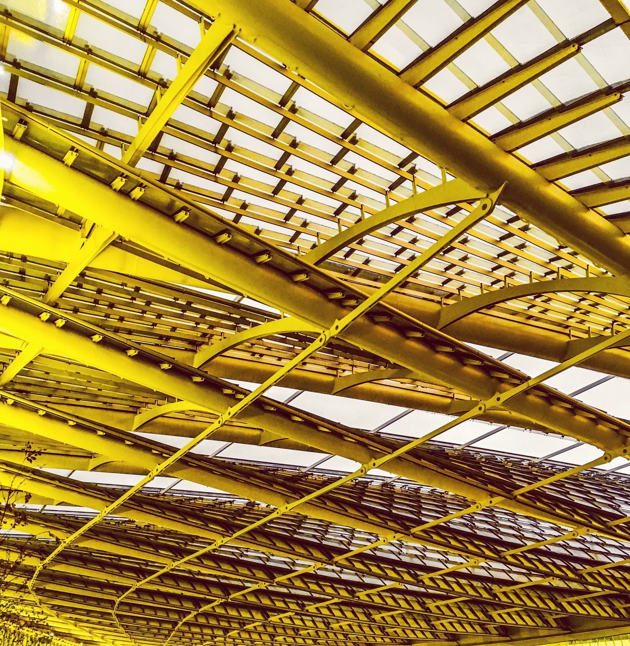 yellow, indoors, no people, low angle view, metal, pattern, ceiling, day, architecture, industry, built structure, backgrounds, factory, full frame, roof, abundance, close-up, sunlight, stack