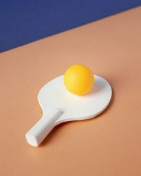 Close-up table tennis equipment on colored background