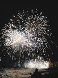 Low angle view of firework display at night