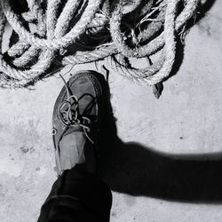 Low section of man by ropes on walkway