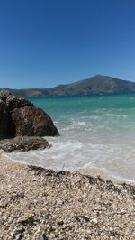 Scenic view of sea against clear blue sky