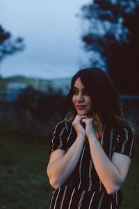 Young woman standing on field