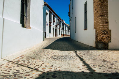 Empty alley amidst buildings in city