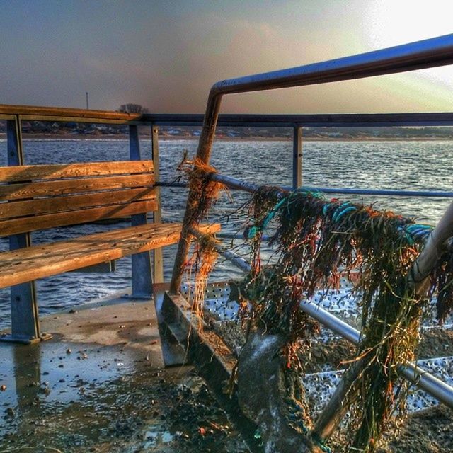 water, wood - material, railing, sea, nature, tranquility, built structure, sky, sunlight, pier, beach, no people, outdoors, wood, plant, day, wooden, beauty in nature, tranquil scene, scenics