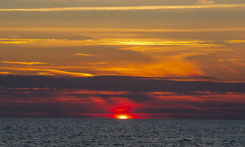 Scenic view of sea against romantic sky at sunset