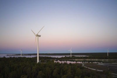 Wind turbines against sky