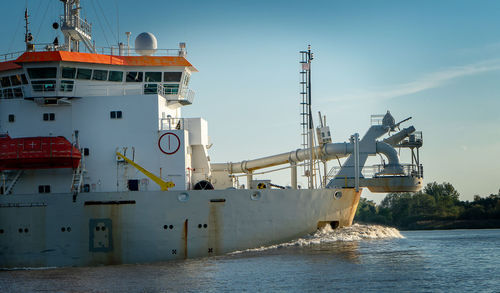 Commercial dock by sea against sky