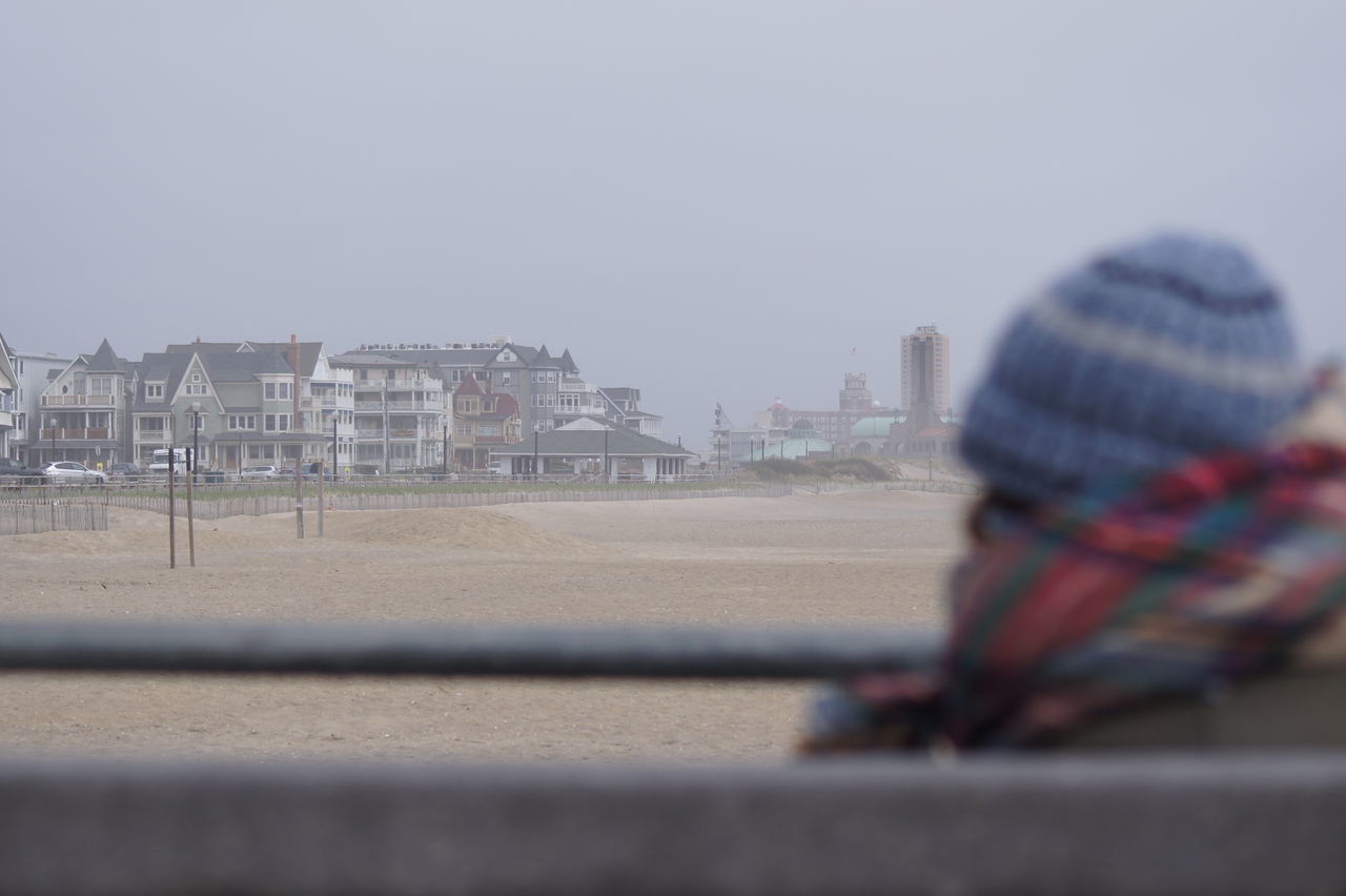 BOY IN CITY AGAINST SKY