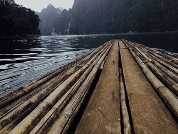 Wooden bridge over river in forest