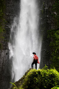 Standing against the langkuik tinggi waterfall in west sumatera, indonesia 