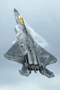 Low angle view of airplane flying against sky