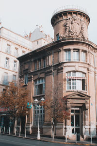 Low angle view of old building in city against clear sky