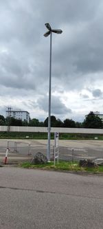 Street light by road against sky